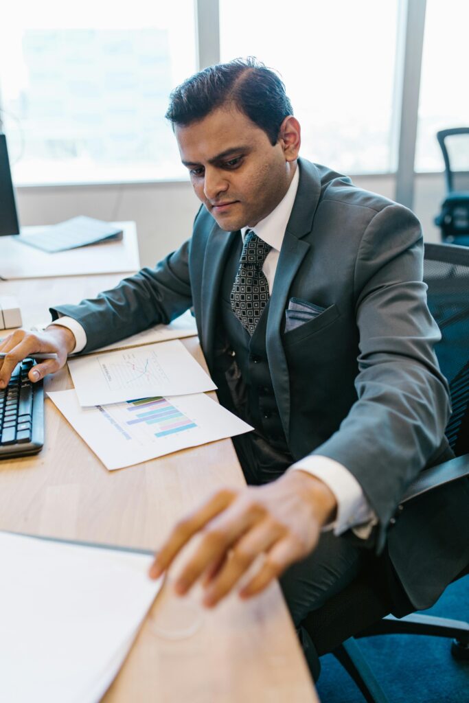 pexels-photo-7580653-7580653 Confident businessman analyzing financial reports at his office desk.